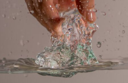 Picking ice cube from waterの写真素材