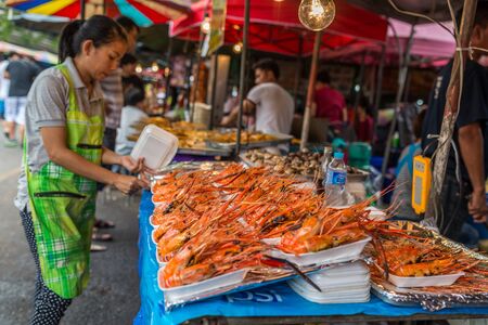 Bangkok, Thailand - Nov 7, 2015 Unidentified woman is selling grilled shrimp at Chatuchak, the biggest weekend market in South East Asia.のeditorial素材