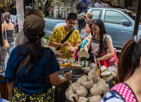 Bangkok, Thailand - Nov 7, 2015 Unidentified tourist is buying Fresh-coconut-ice cream at Chatuchak, the biggest weekend market in South East Asia.のeditorial素材