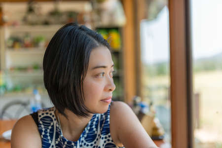 Thai woman look out a windowの写真素材