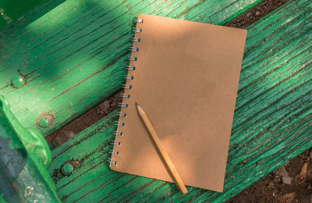 Notebook on old wood benchの写真素材