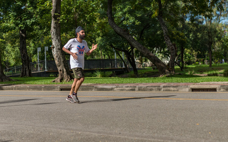 Bangkok, Thailand - Nov 13, 2016 Unidentified old man is jogging in Lumpini Park, the most public park in the downtownのeditorial素材