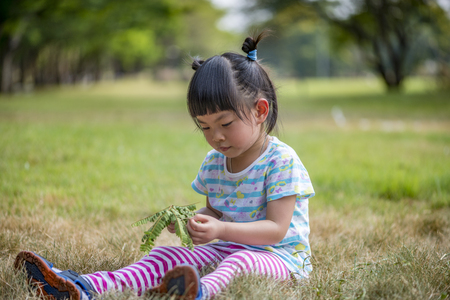 Thai little girl with 3.6 years old in a parkの写真素材