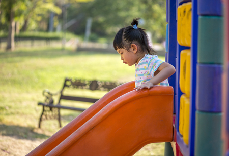 Thai little girl with 3.6 years old in a playground of a public parkの写真素材