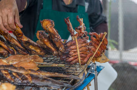 Grilling tradition chicken and pork for sell on street food of Bangkok, Thailandの写真素材