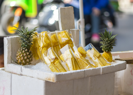 Pine apple in plastic bag on street food of Yaowarat, Bangkok, Thailandの写真素材