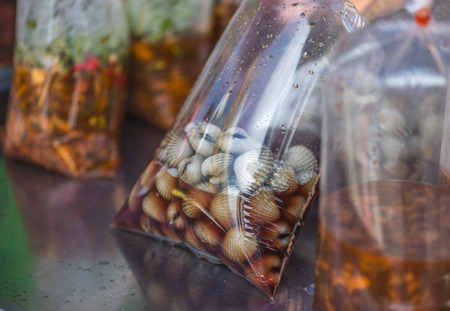 Ferment cockle in plastic bag on street food of Yaowarat, Thailandの写真素材