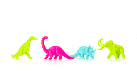 Small colorful dinosaur toy on white backgroundの写真素材