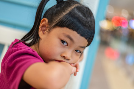 Close up the face of little girl in profile. Emotional face of thinking somthing. Nagative thinking....