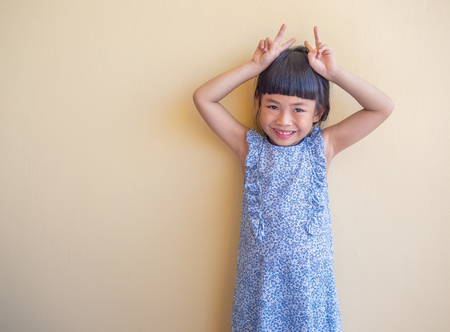 Funny Asian little girl acting as rubbit.の写真素材