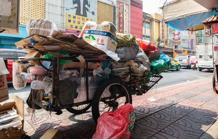 Bangkok, Thailand - Dec 22, 2018 Plastic waste and paper waste on wheelbarrow of a poor man to exchange for money in Chinatown or Yaowarat.のeditorial素材