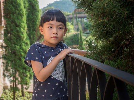 Portrait of a cute Asian small girl posing. Emotional image with space for text.の写真素材