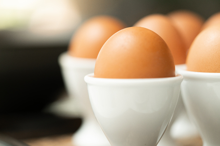 Close up boiled egg in egg cup, row of boiled egg for breakfast in a resturant.の写真素材