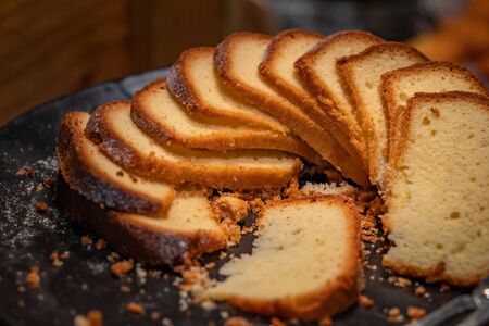 Sliced bread on wooden tray in restaurant, spot light on breads.の写真素材