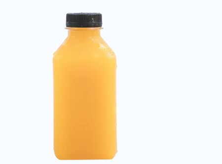 Isolated fresh orange juice in small plastic shaped bottle on white background. Plastic bottle with flat area on the front for product label. Black lid with water droplets on the bottle body and lid.の写真素材