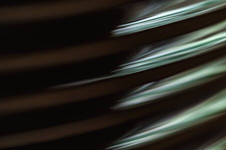 Abstract background, Macro beautiful light reflected on the edges of the stacked ceramic plates....
