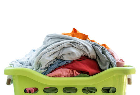 Isolated used cloth in plastic basket on white background, close up on top of plastic basket and used cloth, front view of green basket.の写真素材