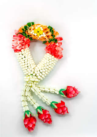 Malai or handmade Thai traditional garlands. Strings flower various together, made from jasmine buds ,orchid ,crown flowers and roses.Thai garland on white background, top view studio shot.の写真素材