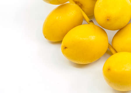 Macro organic fresh Date Palm fruit or Date fruit on white background. Date Palm fruit is on corner...