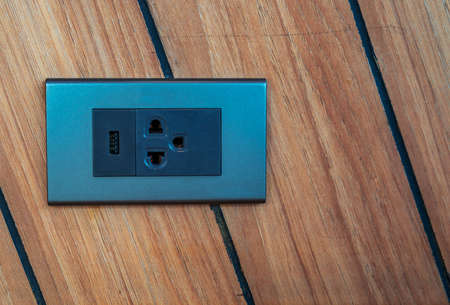 Home interior electrical outlet on strip wooden wall, modern electrical outlet with USB port charger.の写真素材