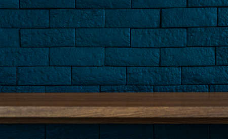 Beautiful background, long wooden desk on dark blue wall, brick wall. Empty space for product display presentation and design.の写真素材