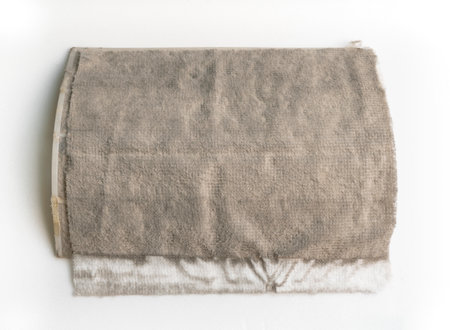 The filter sheet on the air filter inside the air conditioner that full of dirt and mold static electricity. Front view of dirty air conditioner filter, space for text. Image on white background.の写真素材