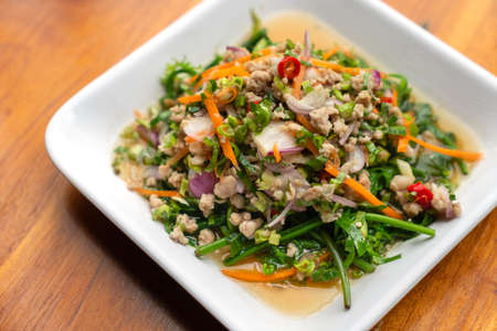 Yum Pak Khut or Diplazium Sour and spicy salad with a combination of chilli, lime, shallot, carrot,...