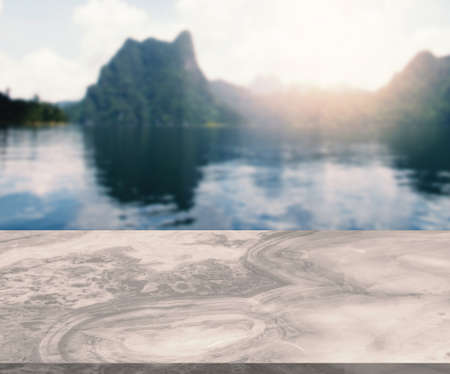 Blank space of marble table with the background of lake and mountainscape in a morning, rising sun,...