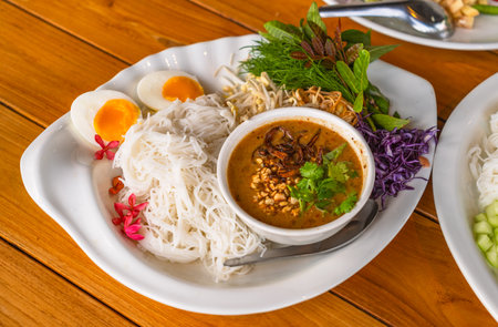 Thai vermicelli or rice noodles with peanut sauce curry, side dish with organic vegetables and...