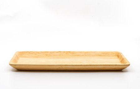 Small serving wooden tray with empty space for bakery or other snacks, side view, image on white...