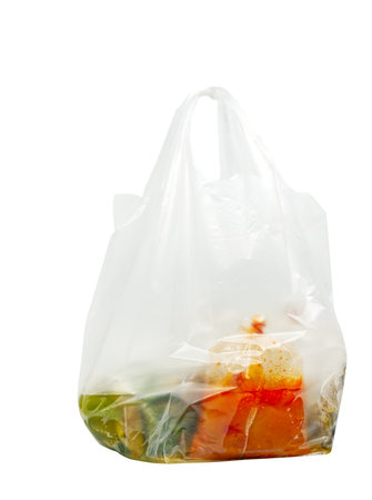 Thailand style of food packing for takeaway, food in cleared plastic bags and tied with rubber bands, food bags in a big plastic bag with holder, isolated image on white background.の写真素材