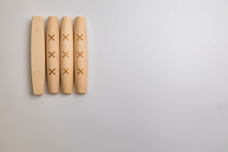 The Yut pieces from the traditional Korean game Yut Nori are neatly arranged on a white background. Close-up.の写真素材