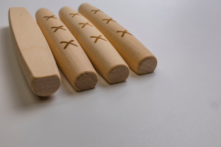 The Yut pieces from the traditional Korean game Yut Nori are neatly arranged on a white background. Close-up.の写真素材