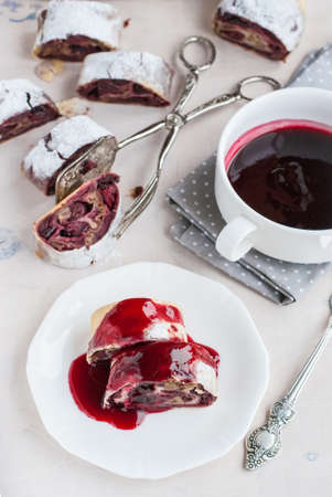 Cherry and walnut strudel on a white table. Selective focusの写真素材