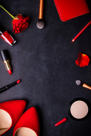 Beauty cosmetic black background. Makeup essentials. Shoes, red lipstick, powder, brushes set. Cosmetic products. Top view. Feminine or fashion background. Cosmetics. Beauty products. Modern womanの写真素材
