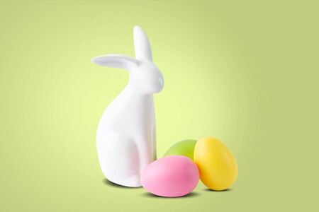 Easter bunny and eggs on green