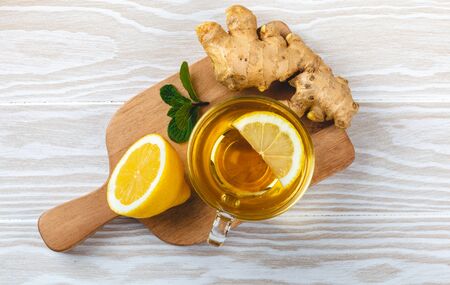 Ginger and lemon tea on wooden table
