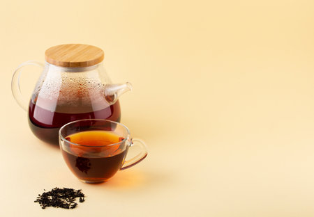 Glass transparent teapot and cup with black tea copy spaceの写真素材