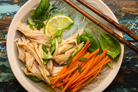 Asian soup with noodles in bowl top view