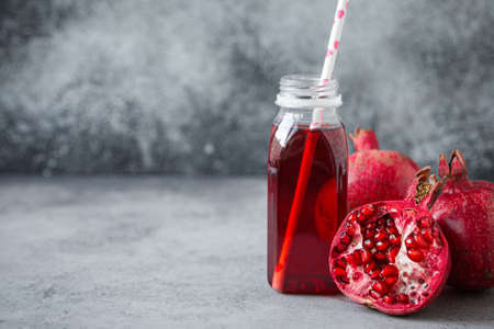 Pomegranate juice in bottle and fruit copy spaceの写真素材