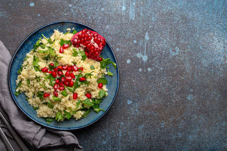 Tabbouleh salad with couscous and pomegranate copy spaceの写真素材