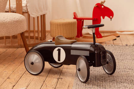 Retro black childrens car in baby nursery roomの写真素材