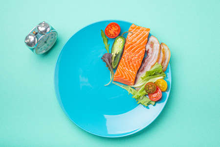 Intermittent fasting low carb hight fats diet concept flat lay, healthy food on blue plateの写真素材
