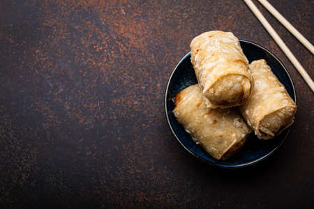Chinese, Thai or Vietnamese traditional dish deep fried spring rolls with filling on plate