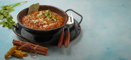 Dal makhani with cream and coriander in bowl is served with spices, traditional dish of India, space for textの写真素材