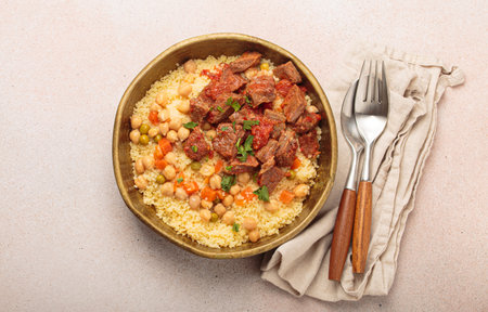 Moroccan couscous with tender meat and chickpea stew in rustic bow top view, Maghreb cuisineの写真素材