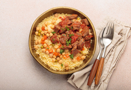 Moroccan couscous with tender meat and chickpea stew in rustic bow top view, Maghreb cuisineの写真素材