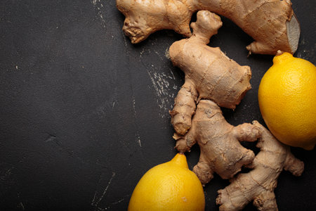 Ginger roots fresh lemons dark background healthy remedy medicine immunity copy space