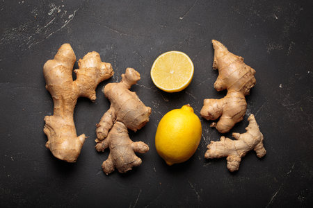 Ginger roots fresh lemons dark background healthy remedy medicine immunityの写真素材