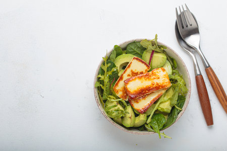 Halloumi avocado salad greens bowl healthy vegetarian diet nutrition top view copy spaceの写真素材